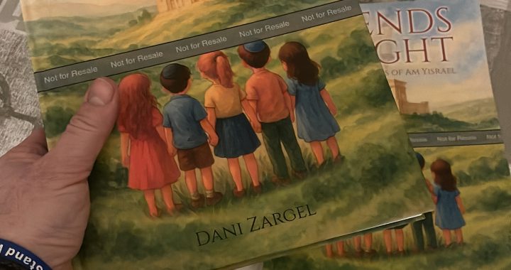 Holding a copy of Legends of the Light